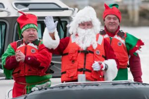 Santa and elves on a boat